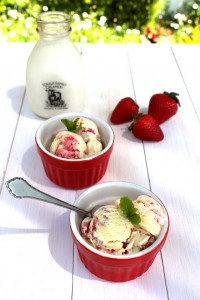 homemade strawberry rhubarb swirl ice cream in small red dessert bowls