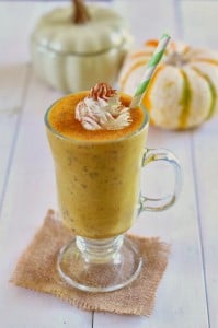 healthy pumpkin pie smoothie topped with whipped cream and pumpkin pie spice