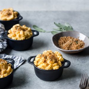 vegan butternut squash mac and cheese in crock with breadcrumbs and sage