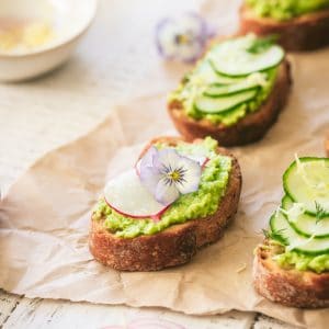 Edamame and Pea Crostini with shaved radish and edible flower