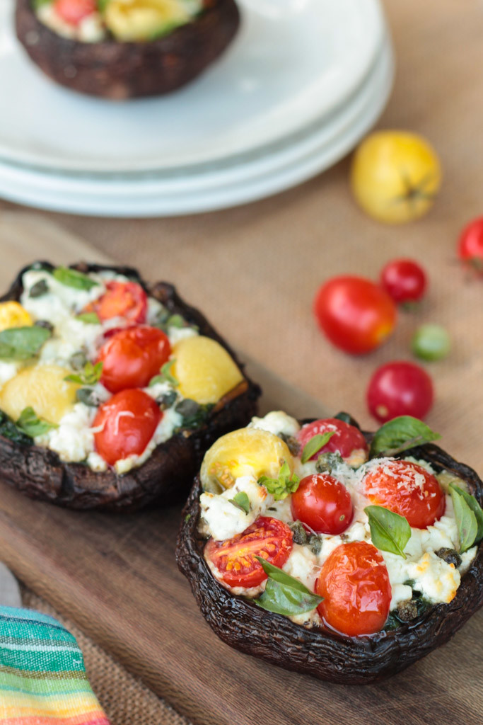 Goat Cheese Stuffed Portobello Mushroom cap Pizzas on a wooden board 
