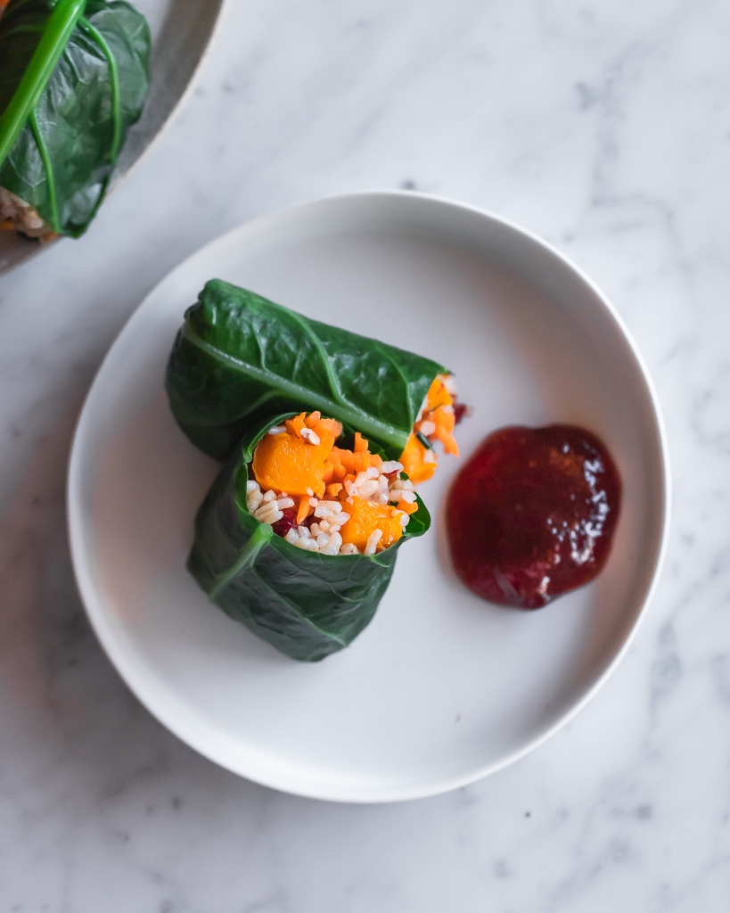 autumn harvest collard green roll with a dollop of cranberry sauce on a plate