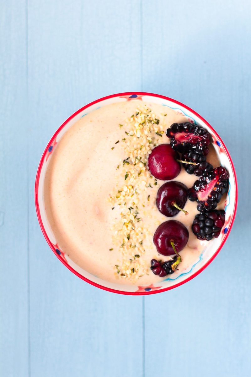 overhead shot of Peanut Butter & Jelly Smoothie Bowl topped with berries and hemp seeds