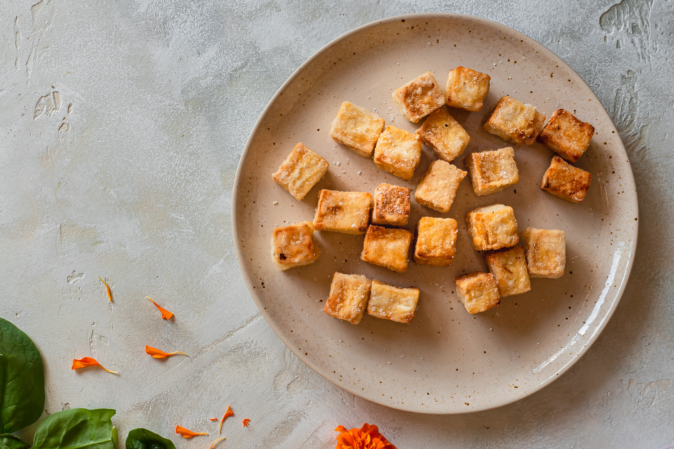cubes of crispy pan-fried tofu on a small plate