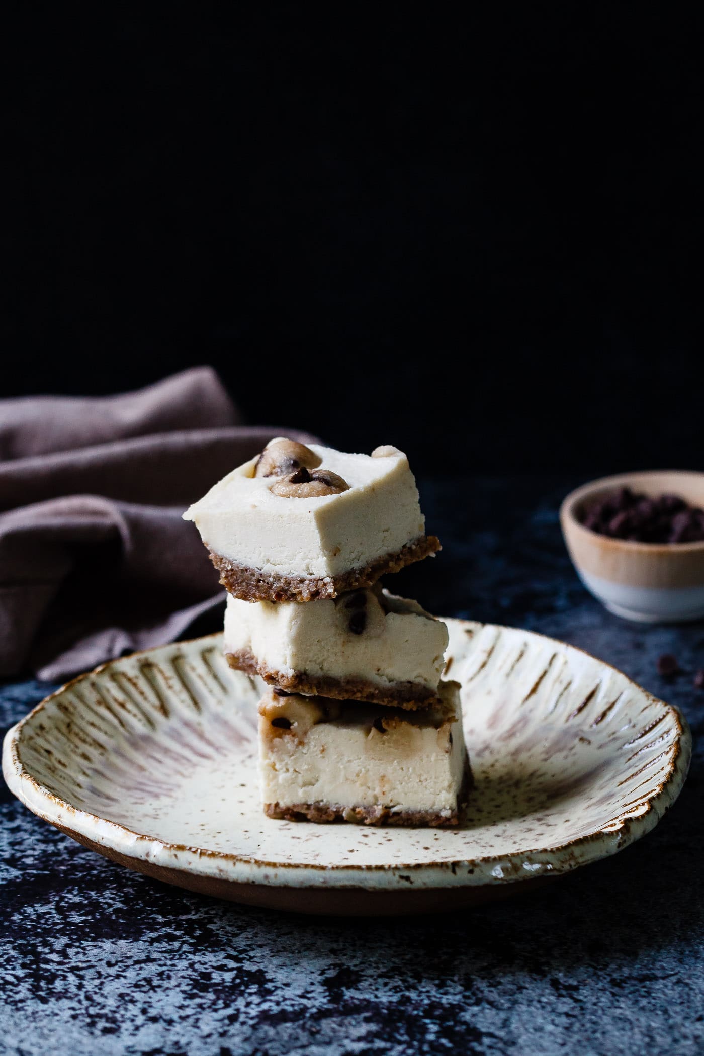 Vegan Cookie Dough Cheesecake Bars stacked on a plate