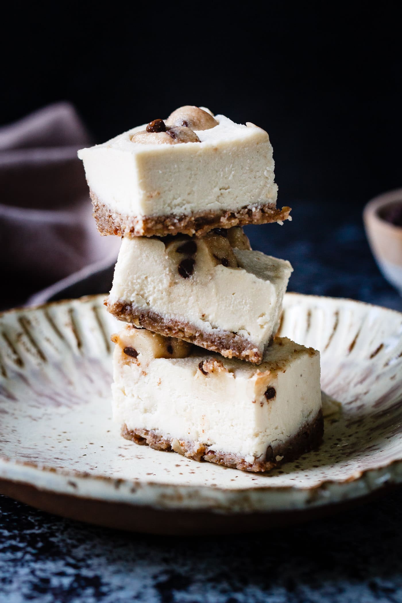 Vegan Cookie Dough Cheesecake Bars stacked on a plate