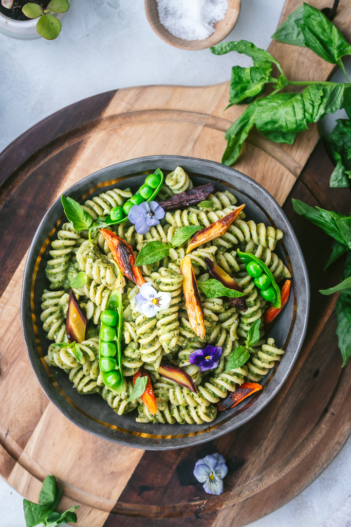 pea pesto pasta with roasted carrots, snap peas and edible flowers