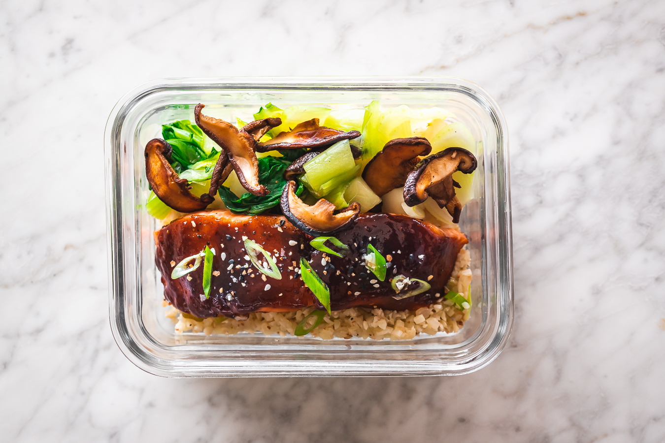 glazed salmon with vegetables in a meal prep container