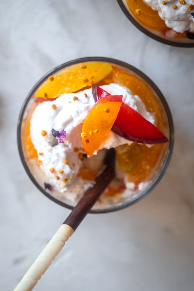 poached plum coconut cream parfaits topped with bee pollen and purple basil