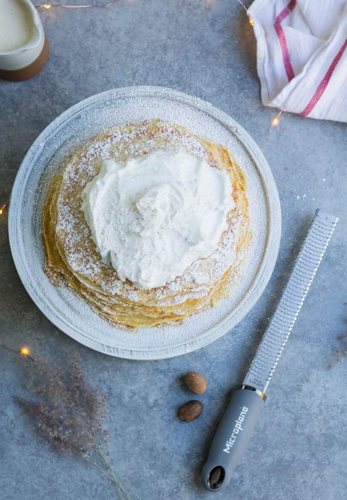 overhead shot of Eggnog Crepe Cake aka. mille feuille crepe cake topped with whipped cream