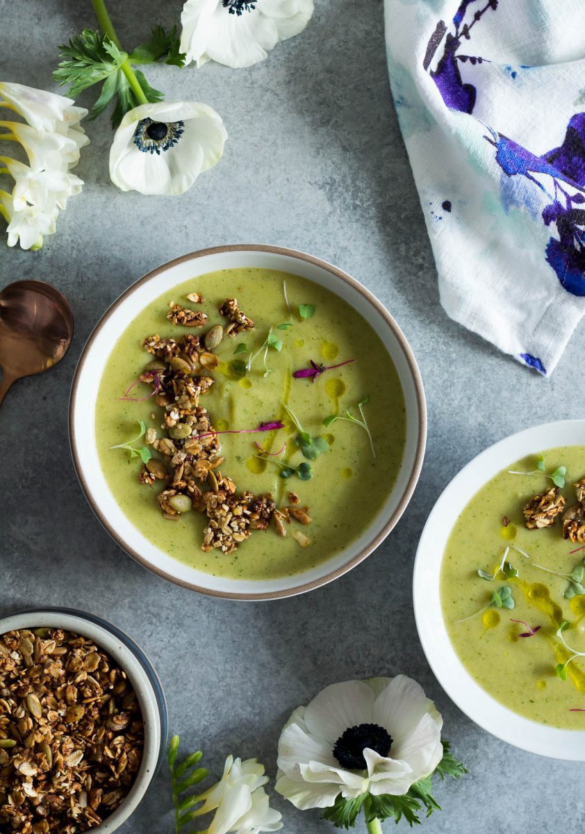 overhead shot of two small bowls of Romanesco Soup topped with homemade savory granola