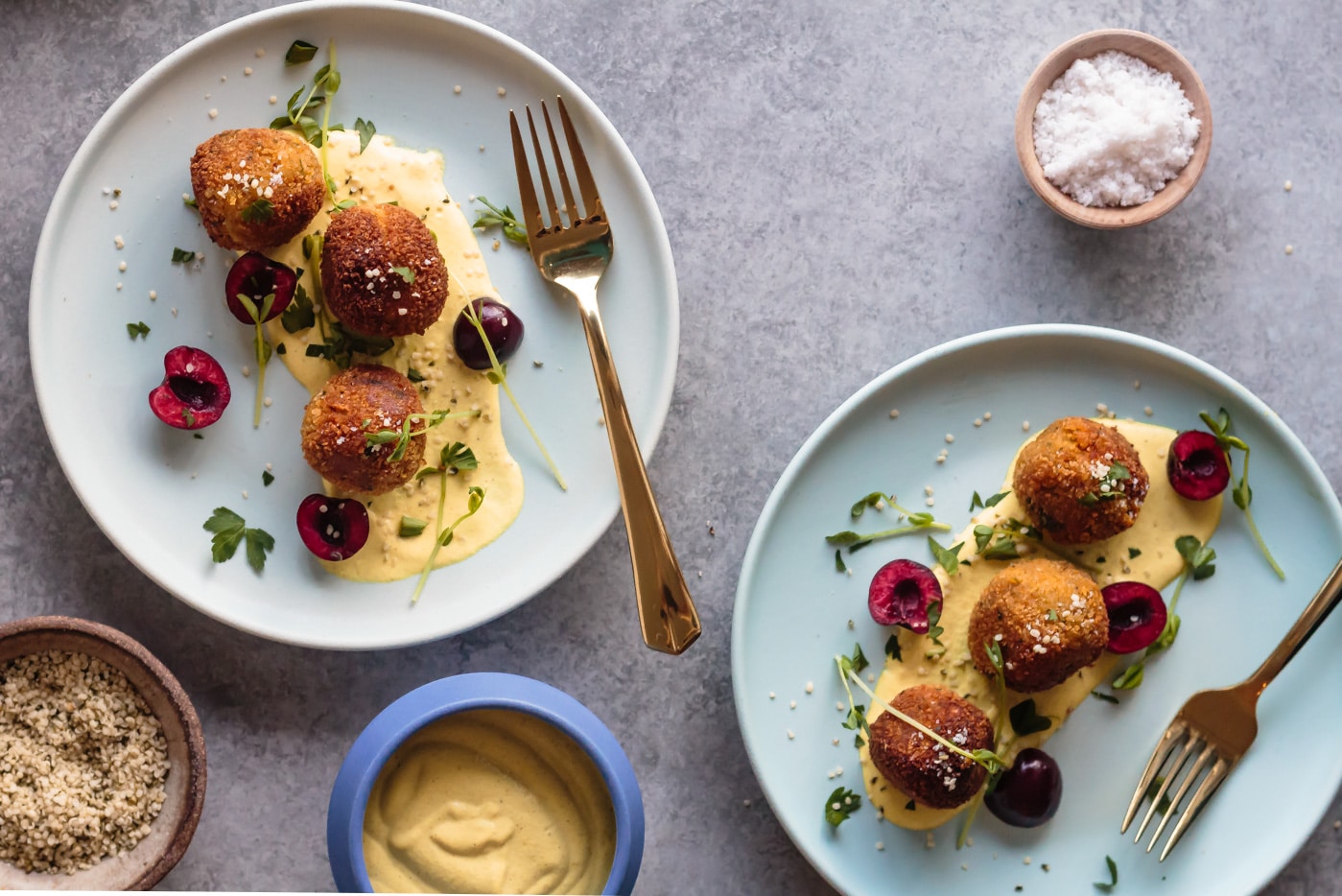 Vegan Lentil Sweet Potato Fritters served with curried cashew cream and fresh cherries