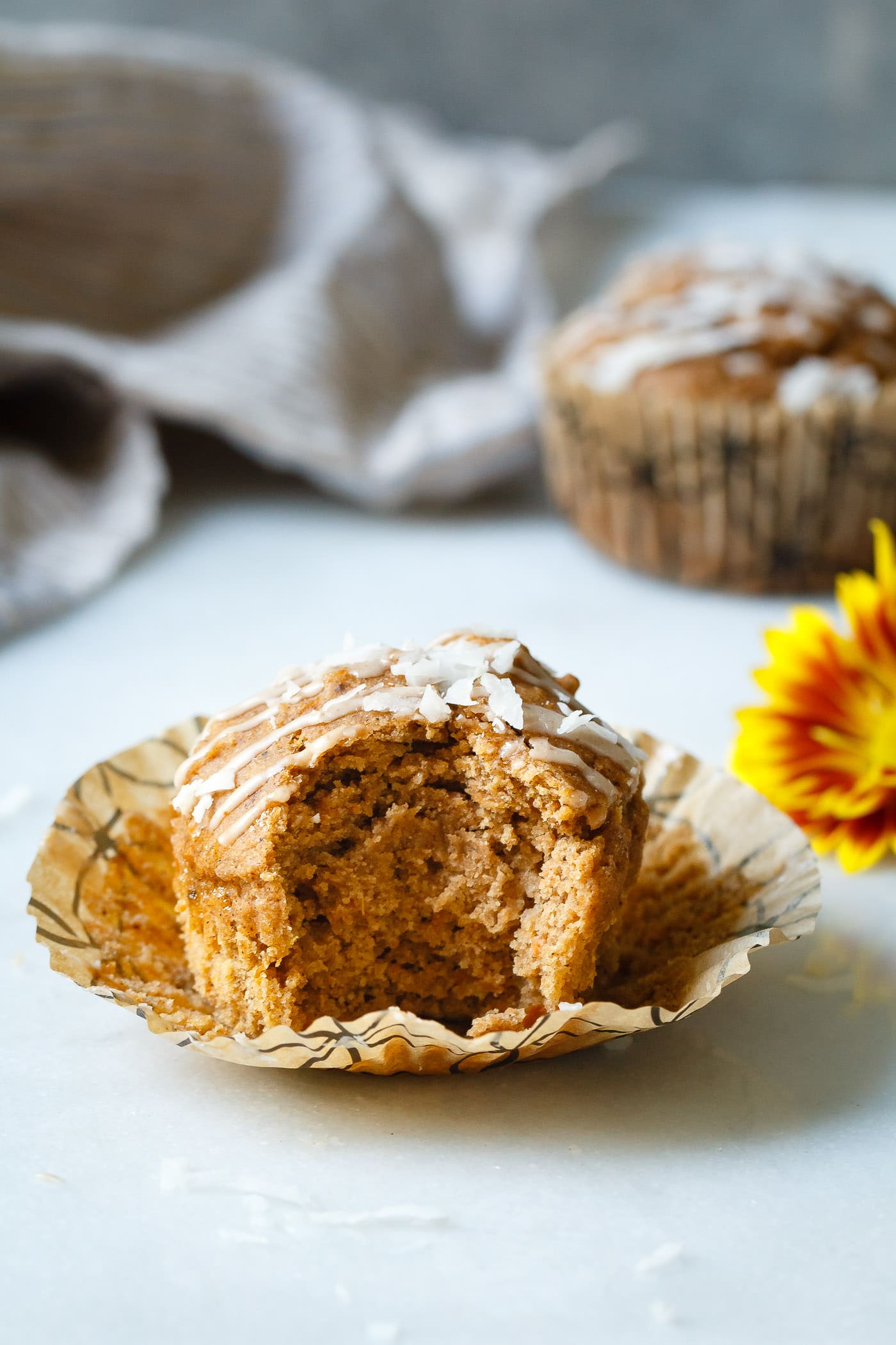 Sweet Potato Coconut Chai Muffins close up with a bite taken out