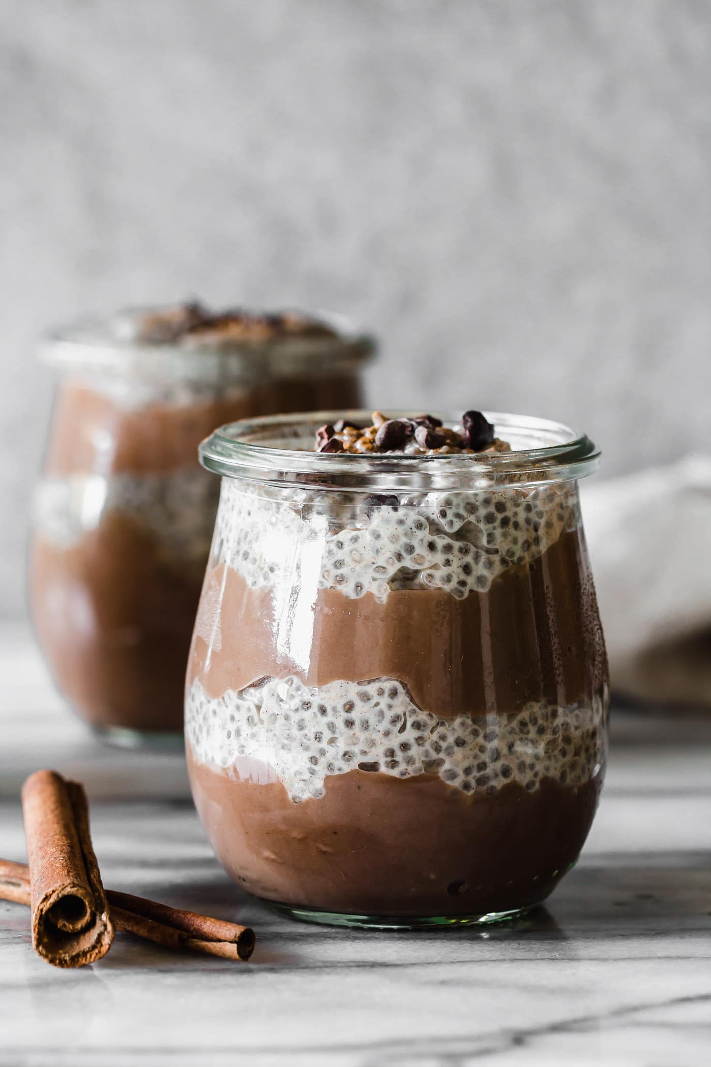 close up of Cacao Horchata Vegan Chia Pudding Parfait layered in dessert jars