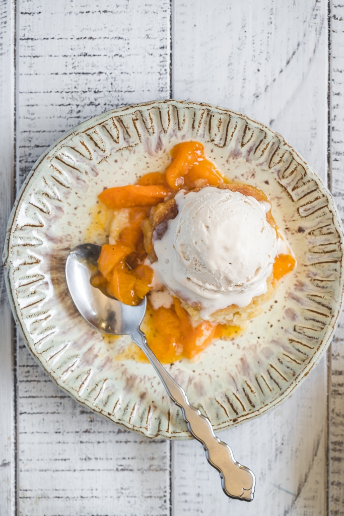 a serving of Apricot Skillet Cobbler with vanilla ice cream