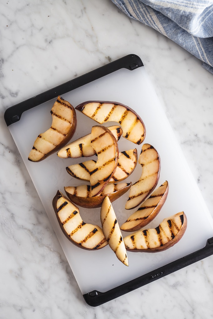 grilled pear wedges on a cutting board