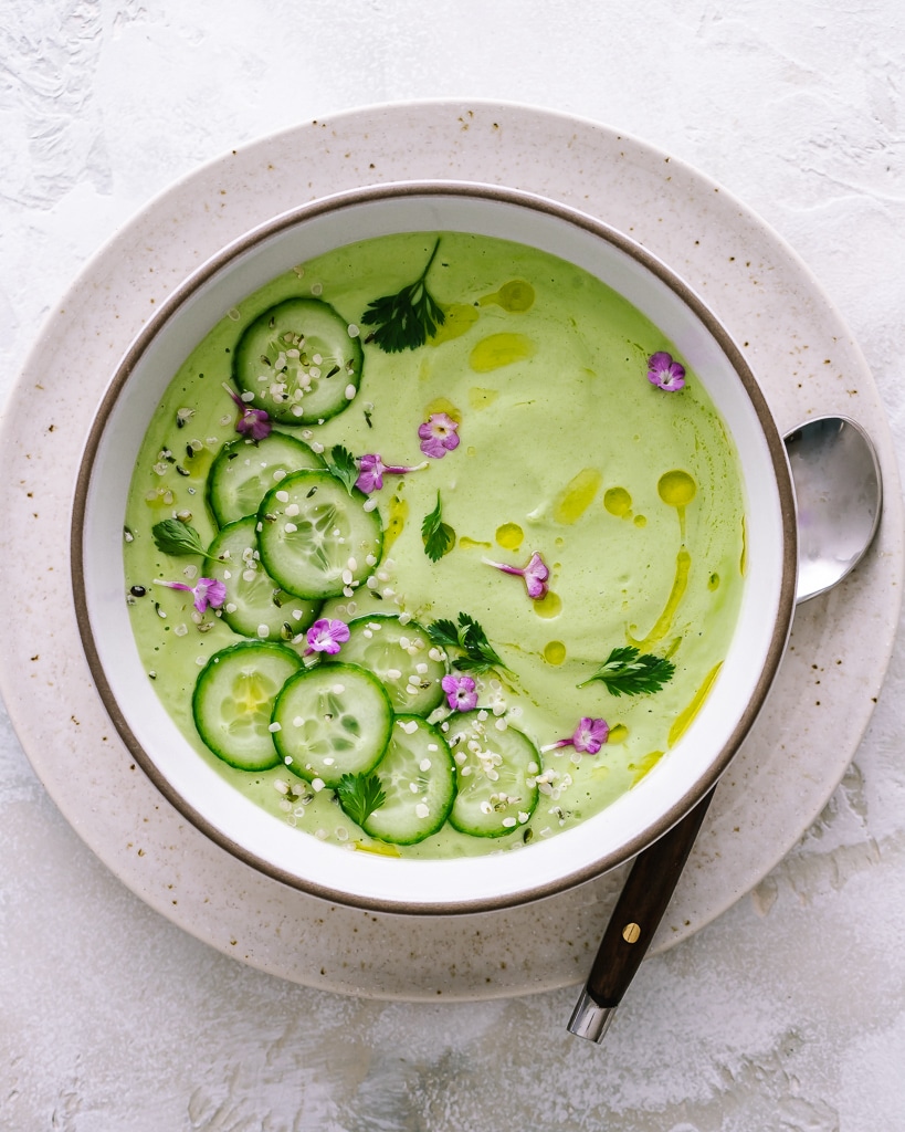 Bowl of cucumber gazpacho with sliced cucumbers on top