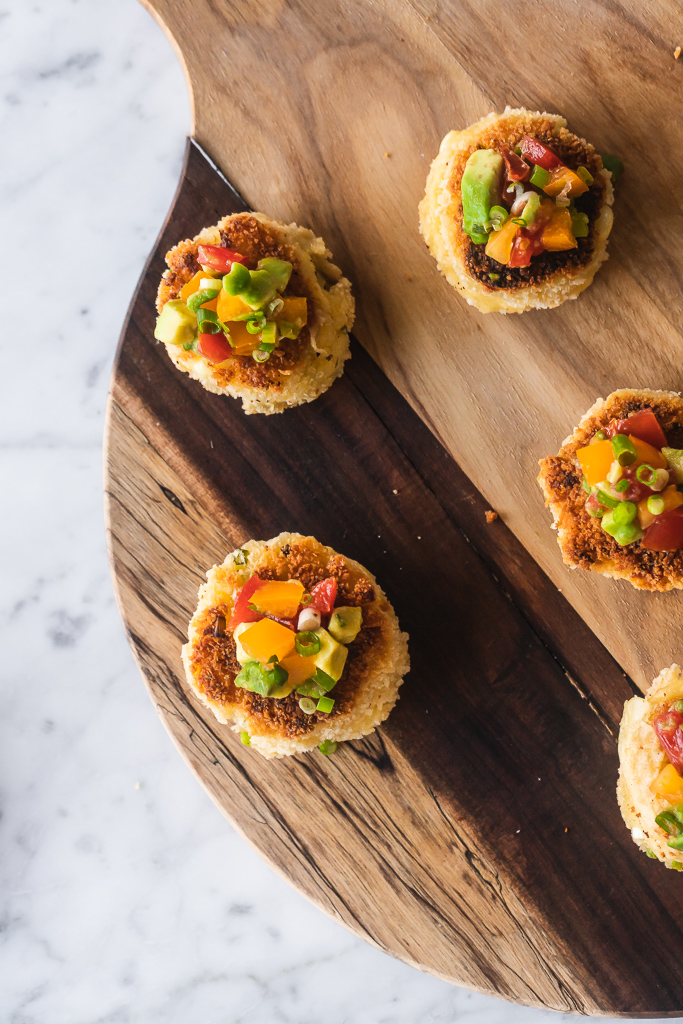 corn fritters with goat cheese and scallions on a wooden cutting board