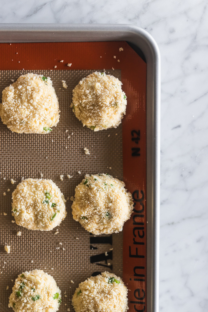 corn fritters before being fried on a baking sheet