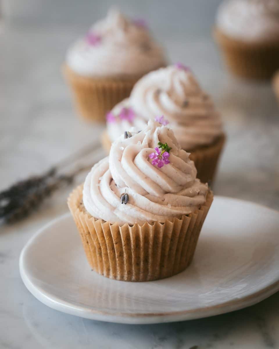 a vegan earl grey cupcake on a white plate
