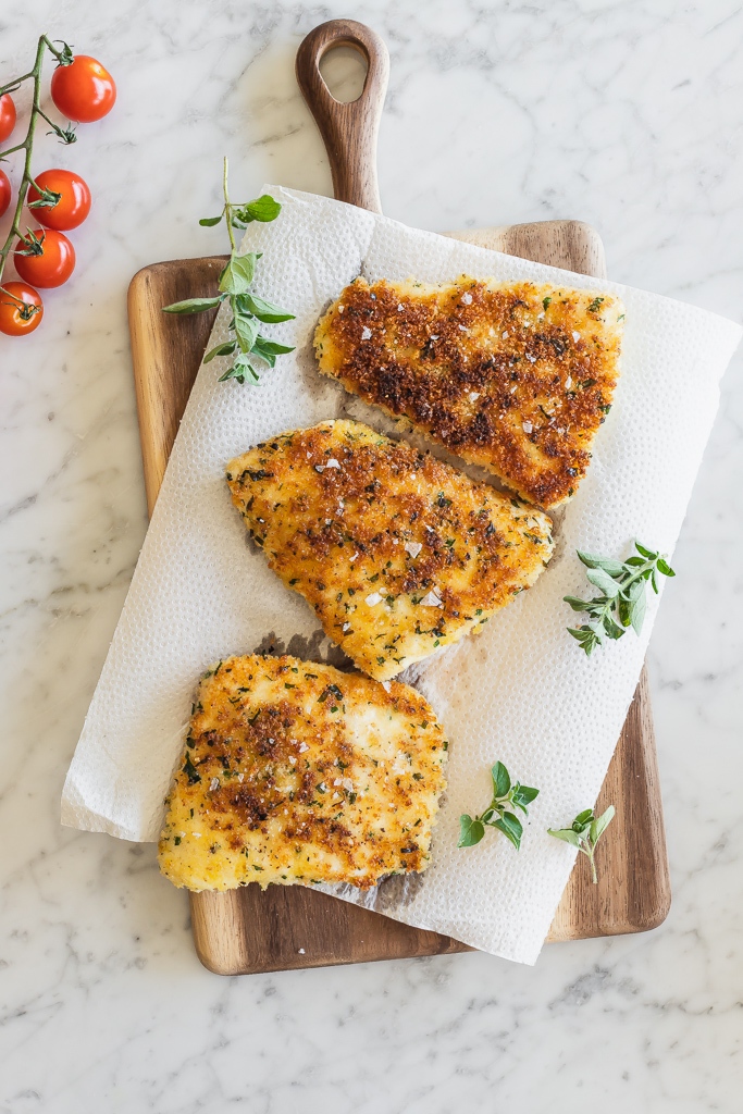 panko crusted halibut filets draining on paper towels 