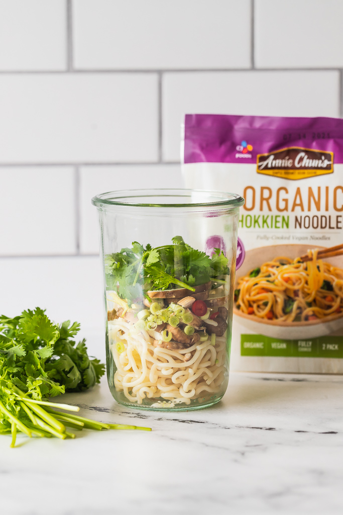 noodles and tom kha gai ingredients in a glass jar