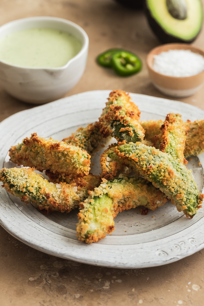 baked avocado fries with panko breadcrumb crust on a white ceramic plate