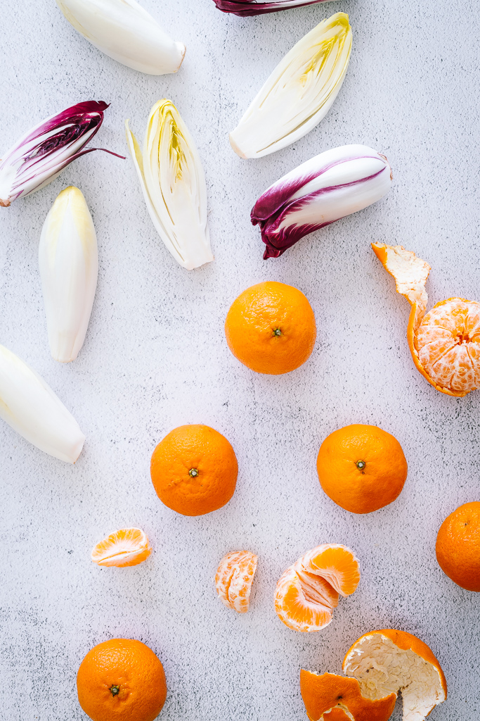 endive hearts and tangerines on a countertop