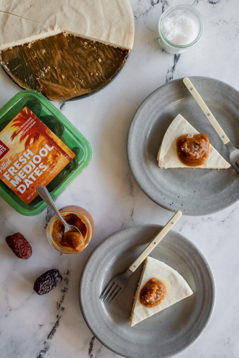 overhead view of vegan cheesecake slices with a jar of date caramel sauce